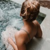 a woman in a hot tub outdoors